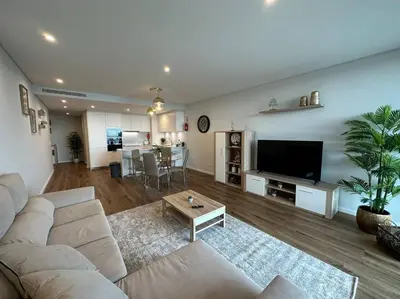a large living room with a couch and a table at Deluxe Bay View in Câmara de Lobos