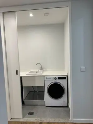 a kitchen with a sink and a washing machine at Deluxe Bay View in Câmara de Lobos
