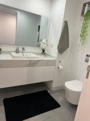 a bathroom with a sink and a toilet and a mirror at Deluxe Bay View in Câmara de Lobos