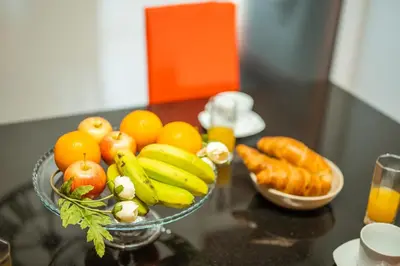 a bowl of fruits and vegetables on a table at Palm Tree House by Amazing Madeira in Câmara de Lobos