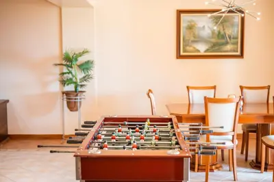 a room with a pool table and a table and chairs at Palm Tree House by Amazing Madeira in Câmara de Lobos