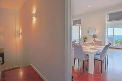 a dining room with a white table and chairs at Pi Houses in Funchal