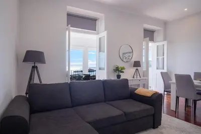 a living room with a couch and a dining room at Pi Houses in Funchal