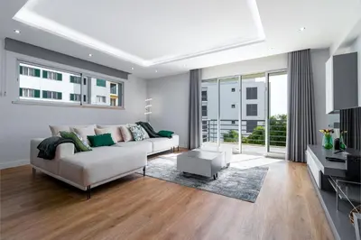 a living room with a white couch and a large window at Barreiros Holidays by Atlântica in Funchal