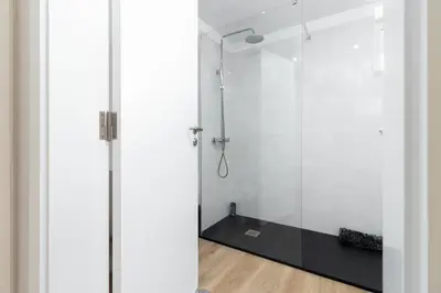 a bathroom with a shower with a glass door at Barreiros Holidays by Atlântica in Funchal
