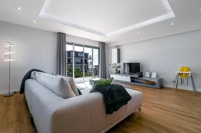 a living room with a white couch and a television at Barreiros Holidays by Atlântica in Funchal