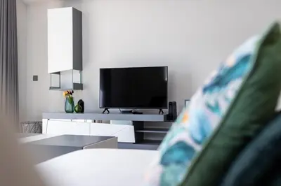 a living room with a tv and a couch at Barreiros Holidays by Atlântica in Funchal