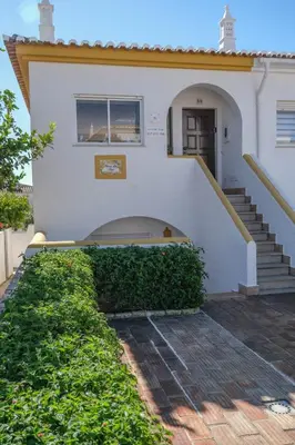 a white house with stairs and a window at Casa da Tia in Luz
