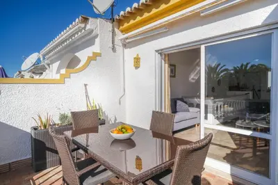 a patio with a table and chairs on a balcony at Casa da Tia in Luz