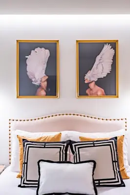 a bedroom with two pictures of wings above a bed at Machim D Arfet House by Homie in Machico