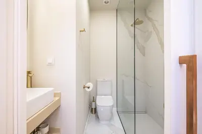 a bathroom with a toilet and a glass shower at Machim D Arfet House by Homie in Machico