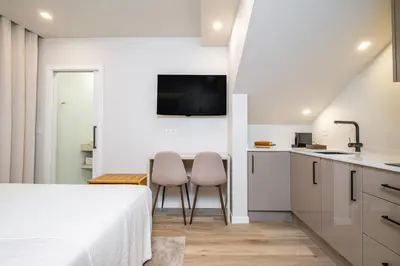 a bedroom with a bed and a table and chairs at Machim D Arfet House by Homie in Machico