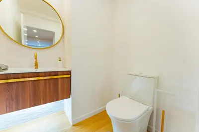 a bathroom with a toilet and a mirror at FLH Funchal Spacious Apartment with Balcony in Funchal
