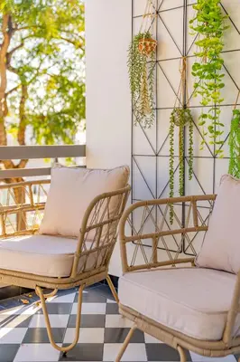 a pair of chairs on a porch with plants at FLH Funchal Spacious Apartment with Balcony in Funchal