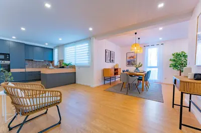 a kitchen and living room with a table and chairs at FLH Funchal Spacious Apartment with Balcony in Funchal