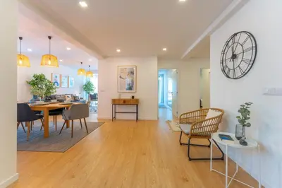 a dining room and living room with a table and chairs at FLH Funchal Spacious Apartment with Balcony in Funchal