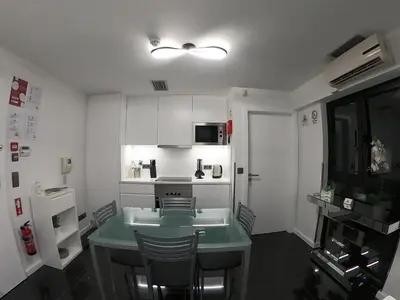 a small kitchen with a green table and chairs at Sea and Sun 4 You - Jardins da Imperatriz in Funchal