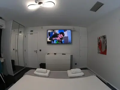 a room with a tv on the wall and a bed at Sea and Sun 4 You - Jardins da Imperatriz in Funchal