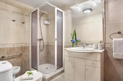 a bathroom with a shower toilet and a sink at Central Living Funchal in Funchal