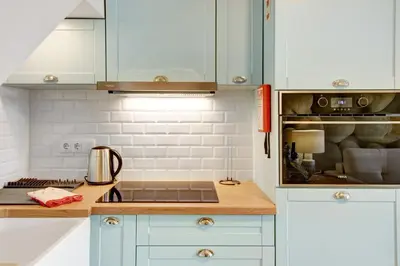 a kitchen with white cabinets and a counter top at Casa do Calhau in Câmara de Lobos