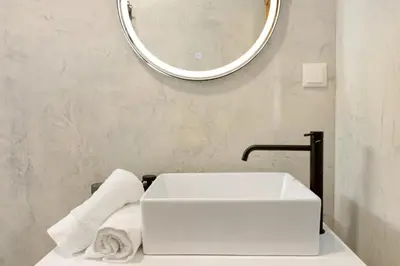 a pile of towels sitting on a bathroom counter at Casa do Calhau in Câmara de Lobos