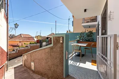 a view from the balcony of a house with a table at Casa das Andorinhas in Câmara de Lobos
