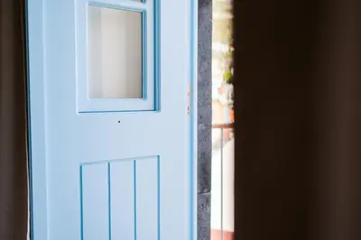 a blue door with a window on it at Casa das Andorinhas - 1 bedroom apartment sleeps 4 in Câmara de Lobos