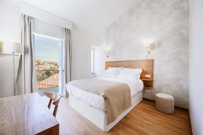 a hotel room with a bed and a window at Casa das Andorinhas - 1 bedroom apartment sleeps 4 in Câmara de Lobos
