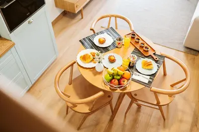a wooden table with a bowl of fruit on it at Casa das Andorinhas - 1 bedroom apartment sleeps 4 in Câmara de Lobos