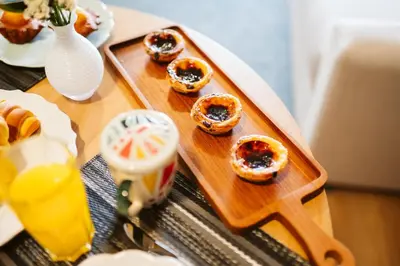 a tray of donuts on a table with a tray of food at Casa do Calhau - 1 bedroom apartment sleeps 4 in Câmara de Lobos