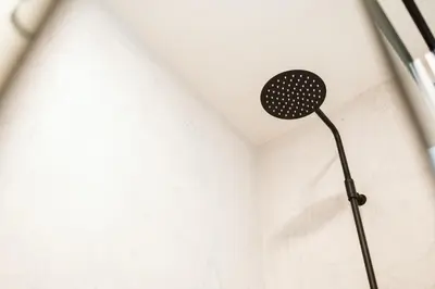 a shower head in the corner of a white wall at Casa do Calhau - 1 bedroom apartment sleeps 4 in Câmara de Lobos