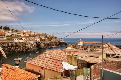a view of a town and the ocean at Casa do Calhau - 1 bedroom apartment sleeps 4 in Câmara de Lobos