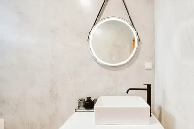 a bathroom with a white sink and a mirror at Casa do Calhau - 1 bedroom apartment sleeps 4 in Câmara de Lobos