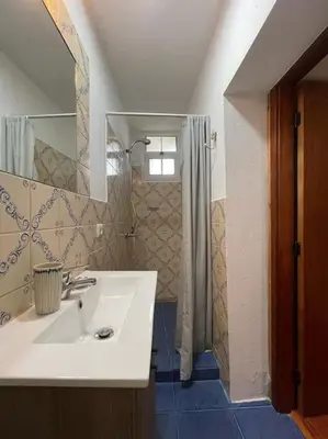 a bathroom with a sink and a shower at Secluded cottage w pool, oceanside view, 3BR, 3BA in Ponta do Sol