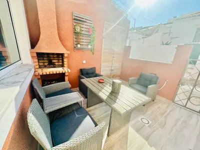 a kitchen with a table and chairs and a counter at Casa dos Avózinhos, Praia da Luz in Luz