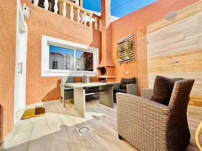 a kitchen with a counter with a bowl of fruit on it at Casa dos Avózinhos, Praia da Luz in Luz