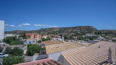 a bathroom with a washing machine and a sink at Casa dos Avózinhos, Praia da Luz in Luz