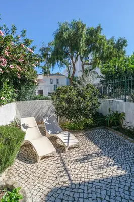 a patio with two chairs and a slide at Casa Caravela, Praia da Luz in Luz