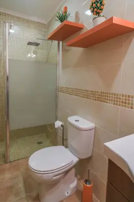 a bathroom with a toilet and a shower and a sink at Casa Caravela, Praia da Luz in Luz