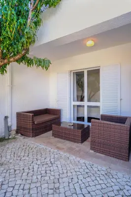 a patio with two couches and a window on a house at Casa Caravela, Praia da Luz in Luz