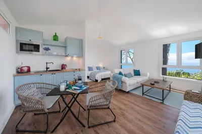 a kitchen and living room with a table and chairs at Magnificent Funchal Villa Quinta D'alegria 4 Bedrooms Panoramic Sea View in Funchal