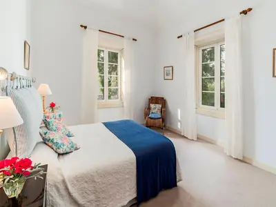 a white bedroom with a bed and two windows at Magnificent Funchal Villa Quinta D'alegria 4 Bedrooms Panoramic Sea View in Funchal