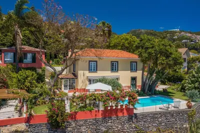 an exterior view of a house with a swimming pool at Magnificent Funchal Villa Quinta D'alegria 4 Bedrooms Panoramic Sea View in Funchal