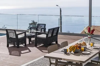 a table with a bowl of fruit on top of a roof at Stunning Funchal Villa 3 Bedrooms Vila Da Portada Panoramic Sea Views in Funchal