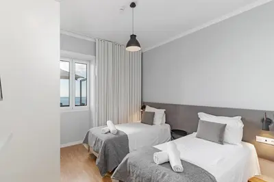 a bedroom with two beds and a window at Stunning Funchal Villa 3 Bedrooms Vila Da Portada Panoramic Sea Views in Funchal