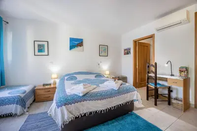a bedroom with two beds and a sink in it at Casa Da Paz in Salema