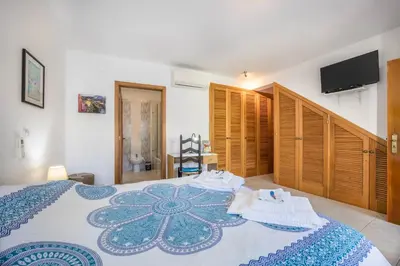 a bedroom with a large bed with towels on it at Casa Da Paz in Salema