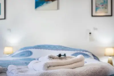 a pile of towels sitting on top of a bed at Casa Da Paz in Salema