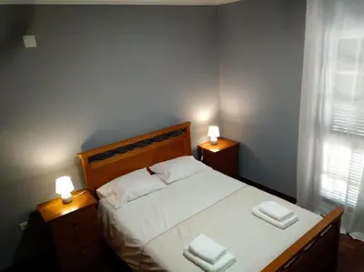 a bedroom with a bed with two towels on it at Casa MAR in Madalena do Mar