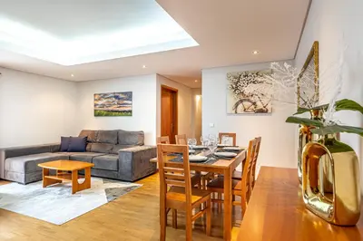 a living room with a table and a couch at Machico City Apt in Machico